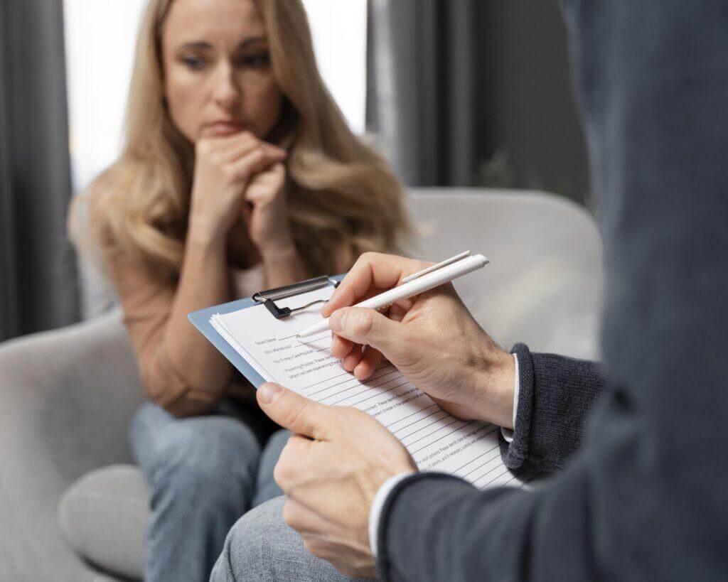 counselor-taking-notes-besides-woman